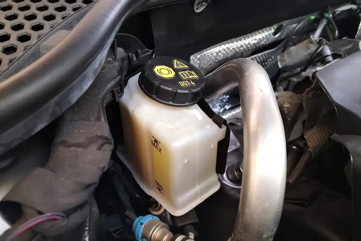 El dep&oacute;sito de l&iacute;quido de frenos DOT 4, con marcas de nivel m&iacute;nimo y m&aacute;ximo, se encuentra en el compartimento del motor.
